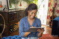 Smiling woman using digital tablet at home