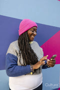 Beautiful woman using phone on colorful background
