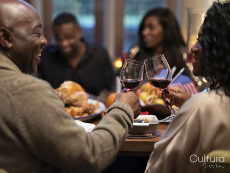 Family drinking red wine at Thanksgiving dinner