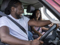 Smiling couple traveling in van