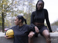 Two female friends outdoors holding basketball ball