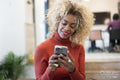 Smiling woman using smart phone in office