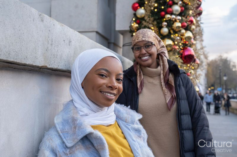 Portrait of young female tourists in hijabs during Christmas time
