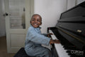 Smiling boy playing piano