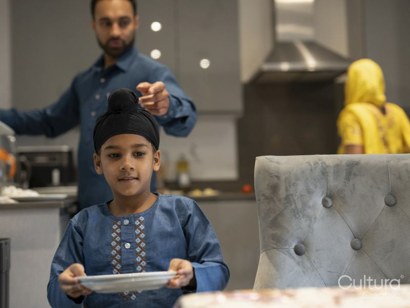 Father and son setting table together