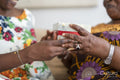 Close-up of woman giving gift to mother at home