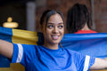 Woman holding national flag in pub
