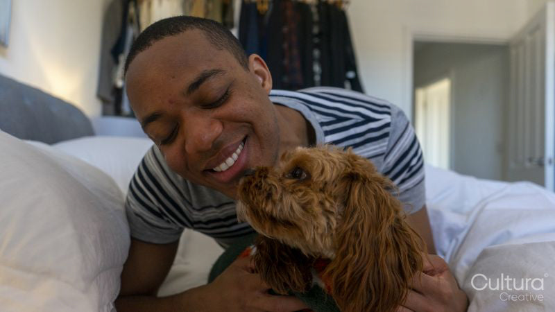 Man lying in bed with dog
