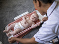 Nurse taking growth measurements of baby girl