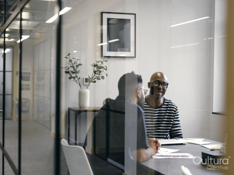 Two men talking in office