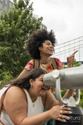 Two women using telescope for sightseeing