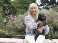 Portrait of senior woman holding dog