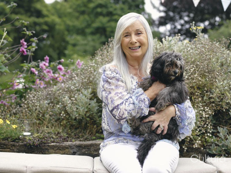 Portrait of senior woman holding dog