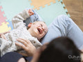 Boy laying down on mothers lap and laughing