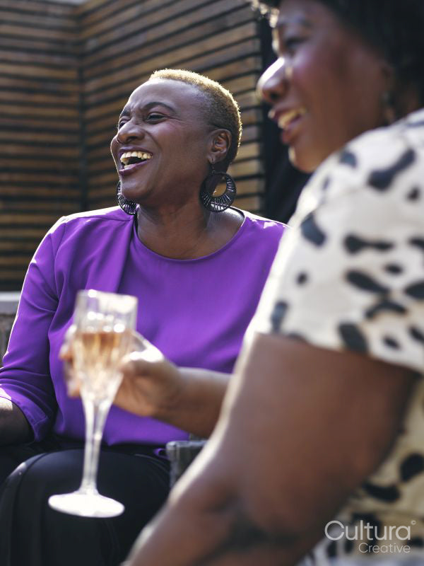 Two women relaxing in backyard