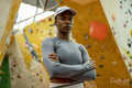Portrait of woman in front of climbing wall