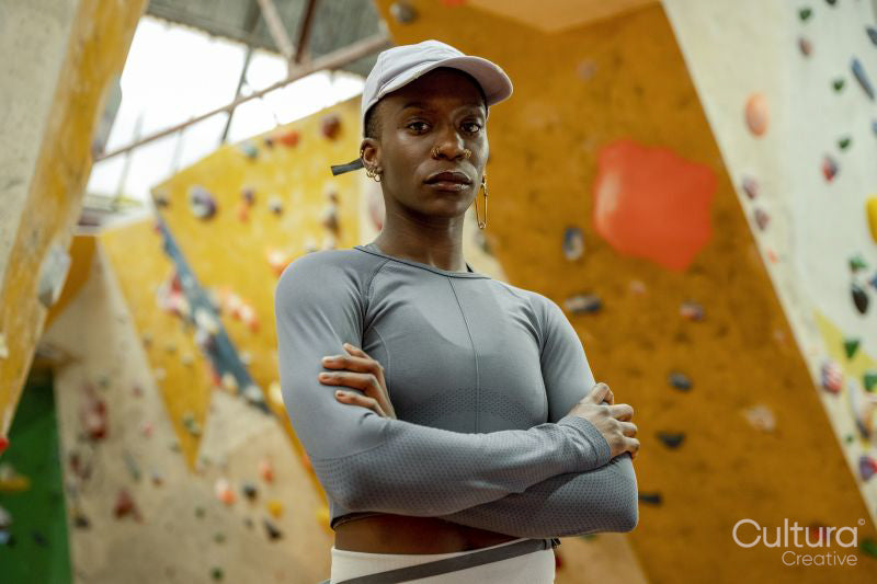 Portrait of woman in front of climbing wall