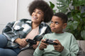 Mother and son playing video games at home