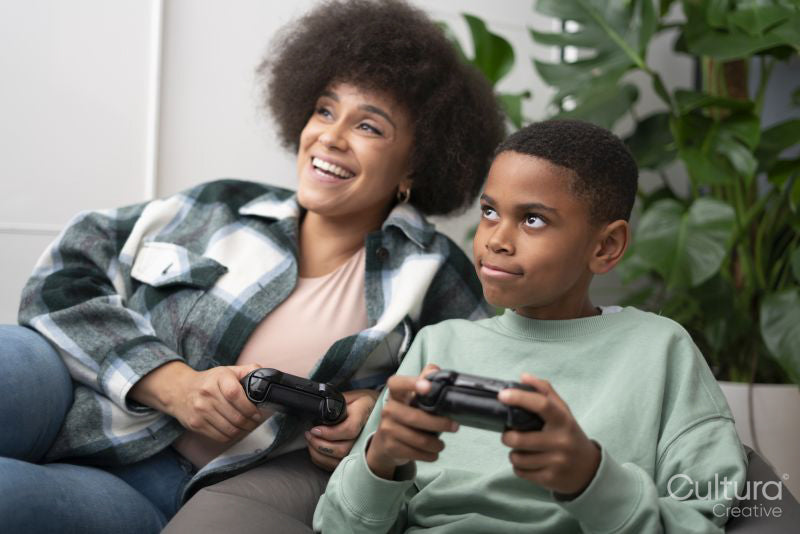 Mother and son playing video games at home