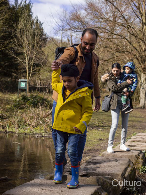 Parents with two sons in park