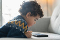 Boy using digital tablet at home