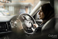 Young woman wearing hijab driving car