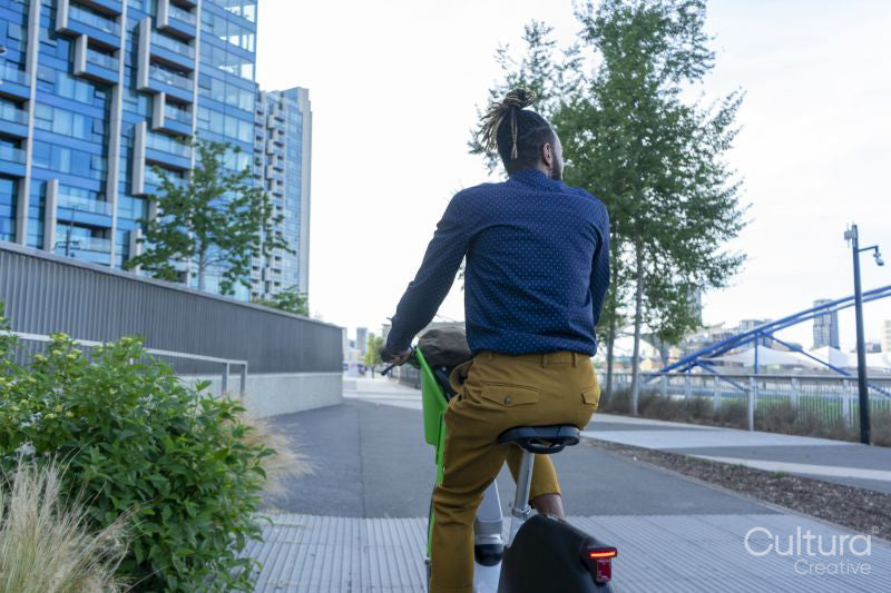 Businessman riding rental bicycle