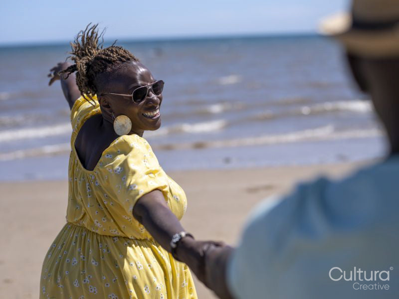 Mature couple holding hands on beach