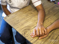 Nurse and patient holding hands, close up