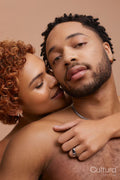 Studio portrait of happy young couple embracing