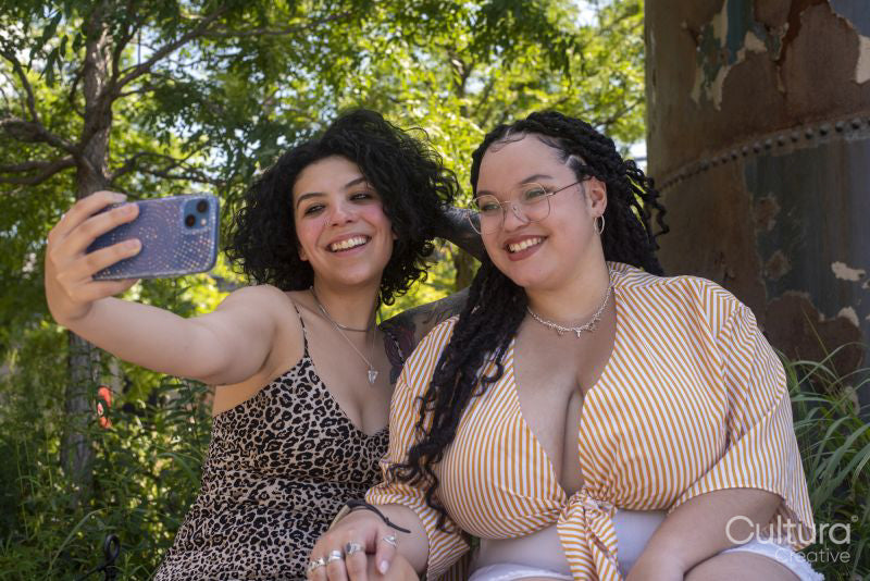 Smiling couple taking selfie in park