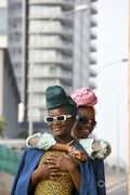 Fashion portrait of two women standing in urban street