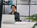 Woman using laptop in office