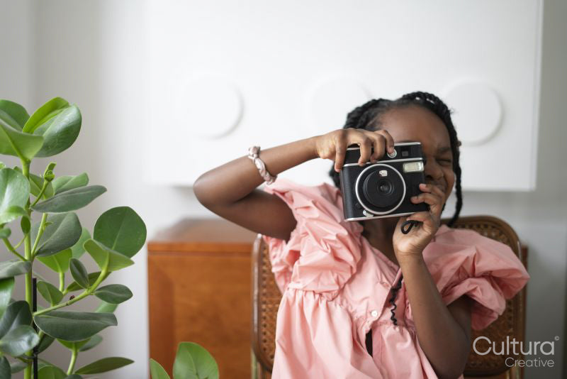 Girl taking photo with camera