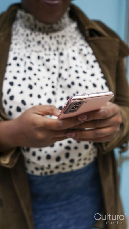 Mid section of woman using phone