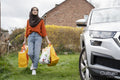 Woman wearing hijab returning home with shopping bags