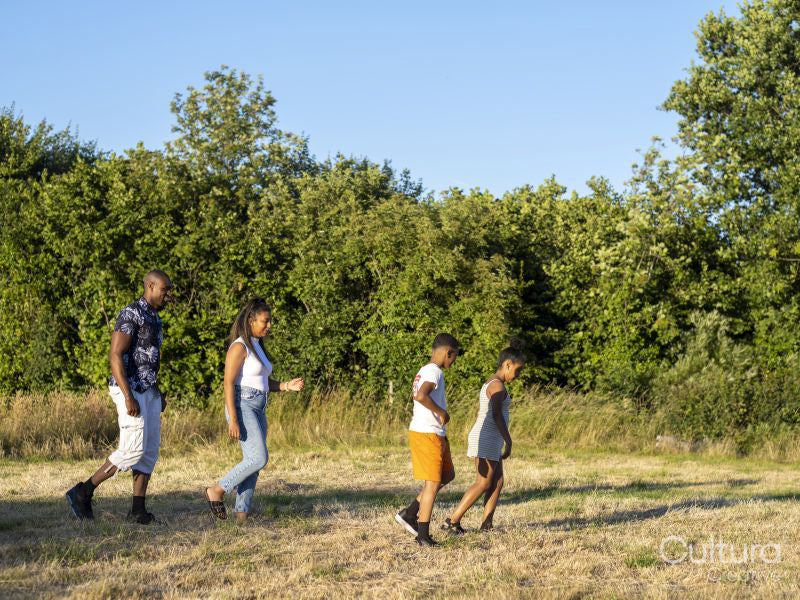 Family with children walking in countryside