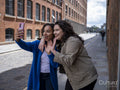 Smiling couple having video call on street