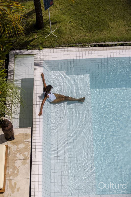 Woman relaxing in swimming pool