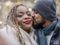 Man kissing girlfriend on cheek