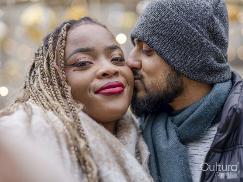 Man kissing girlfriend on cheek