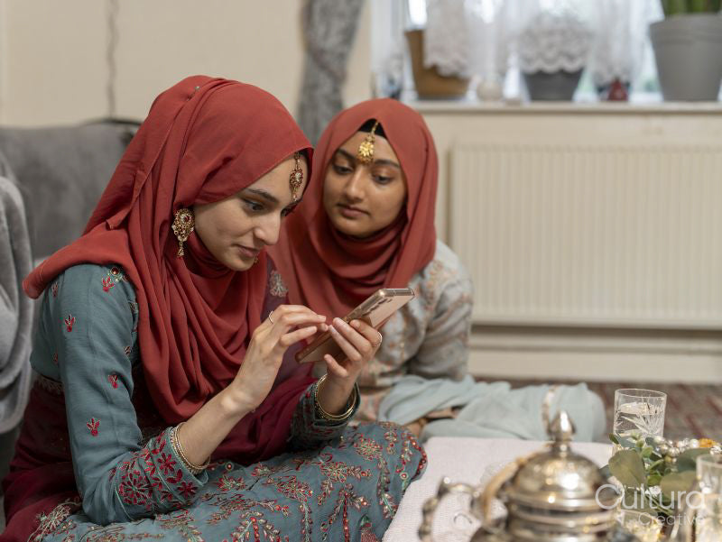 Women using smart phone at table