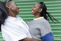 Stylish female couple smiling and hugging