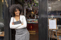 Portrait of smiling cafe owner at doorway