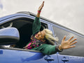 Smiling woman leaning out of van window