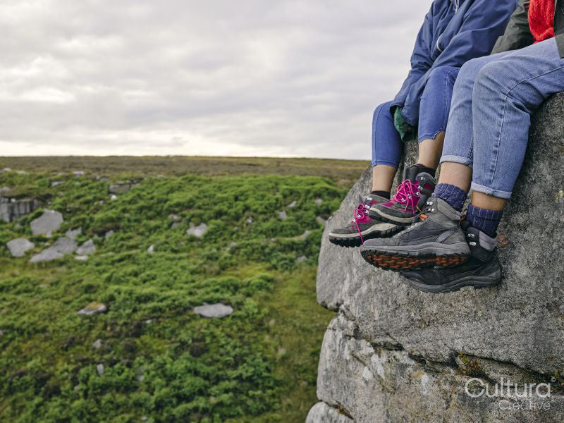 Legs of hikers sitting on rocks