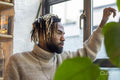 Man looking through window