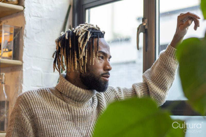 Man looking through window