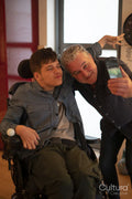 Father taking selfie with disabled son
