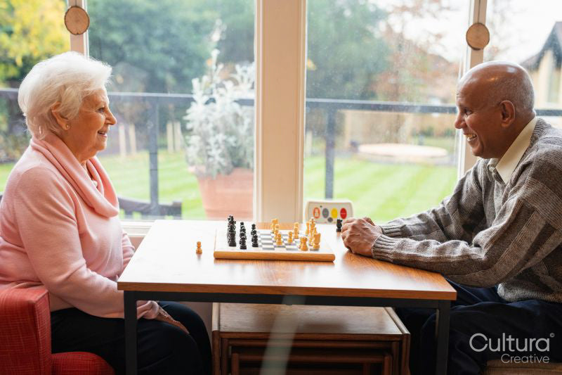 Senior people playing chess in nursing home